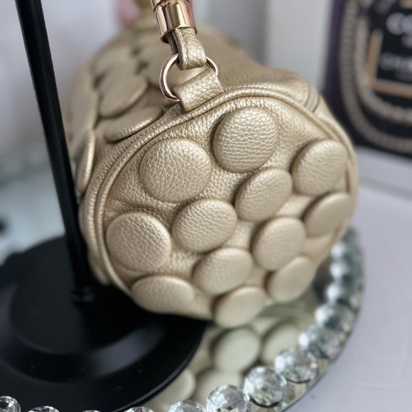 unique design with embossed circular details and a structured, metallic handle. - Picture 8 of 12